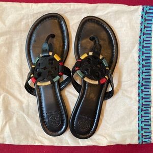 Tori Burch black sandals with colorful detailing.